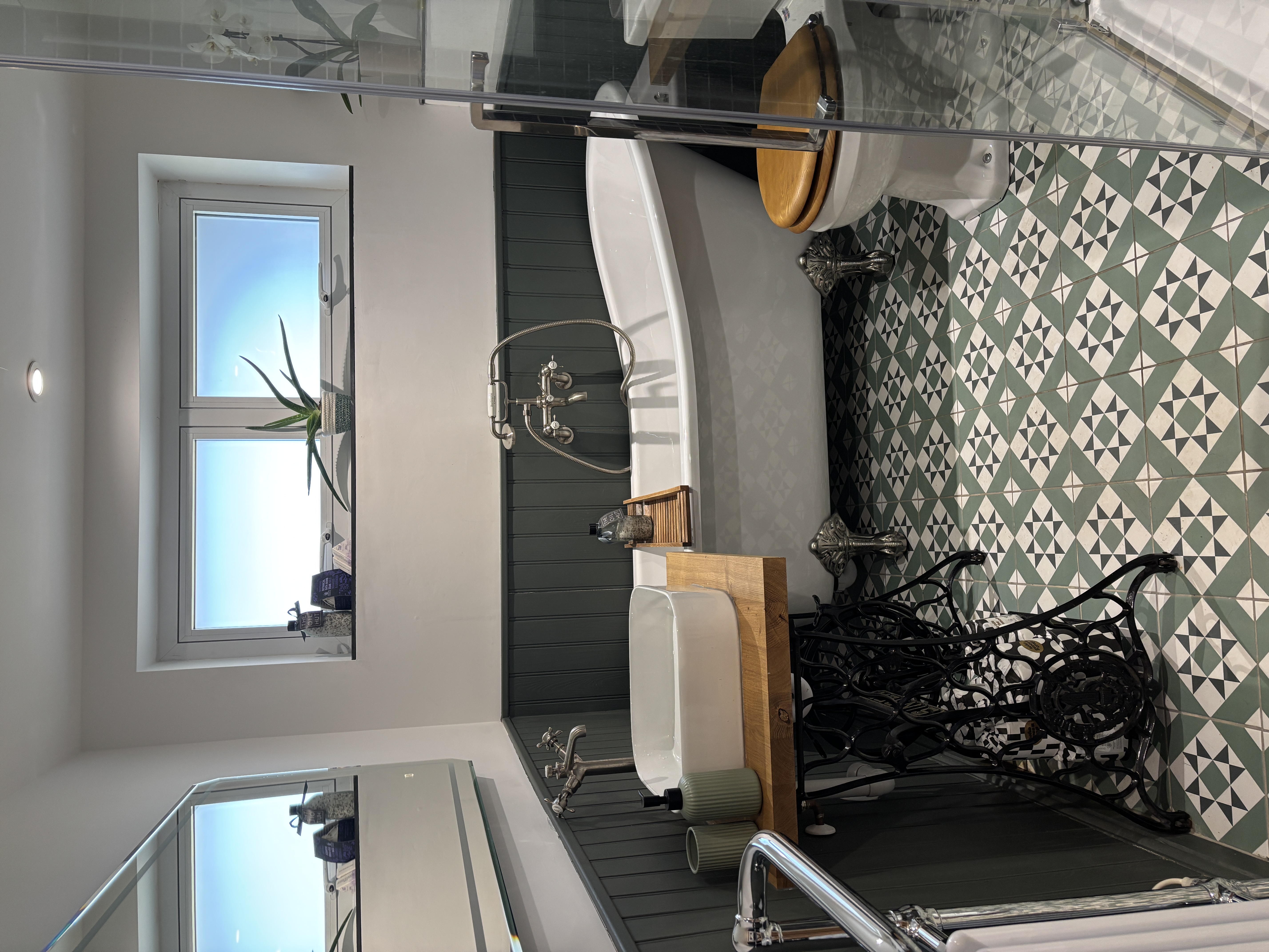 Freestanding bath and restored sink unit to create traditional bathroom in modern build.