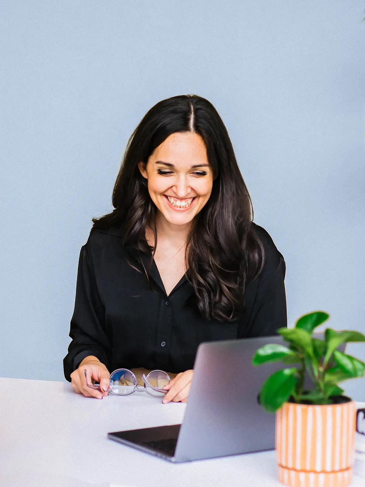 Emma Hubanks, website copywriter and strategist at Luma Liz, smiling while working on website copywriting services.