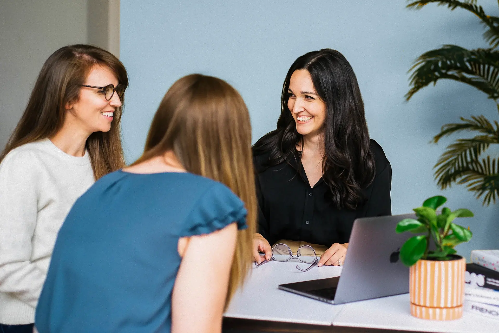 Web designer Emma Hubanks meeting with small business clients to plan website strategy at Luma Liz studio