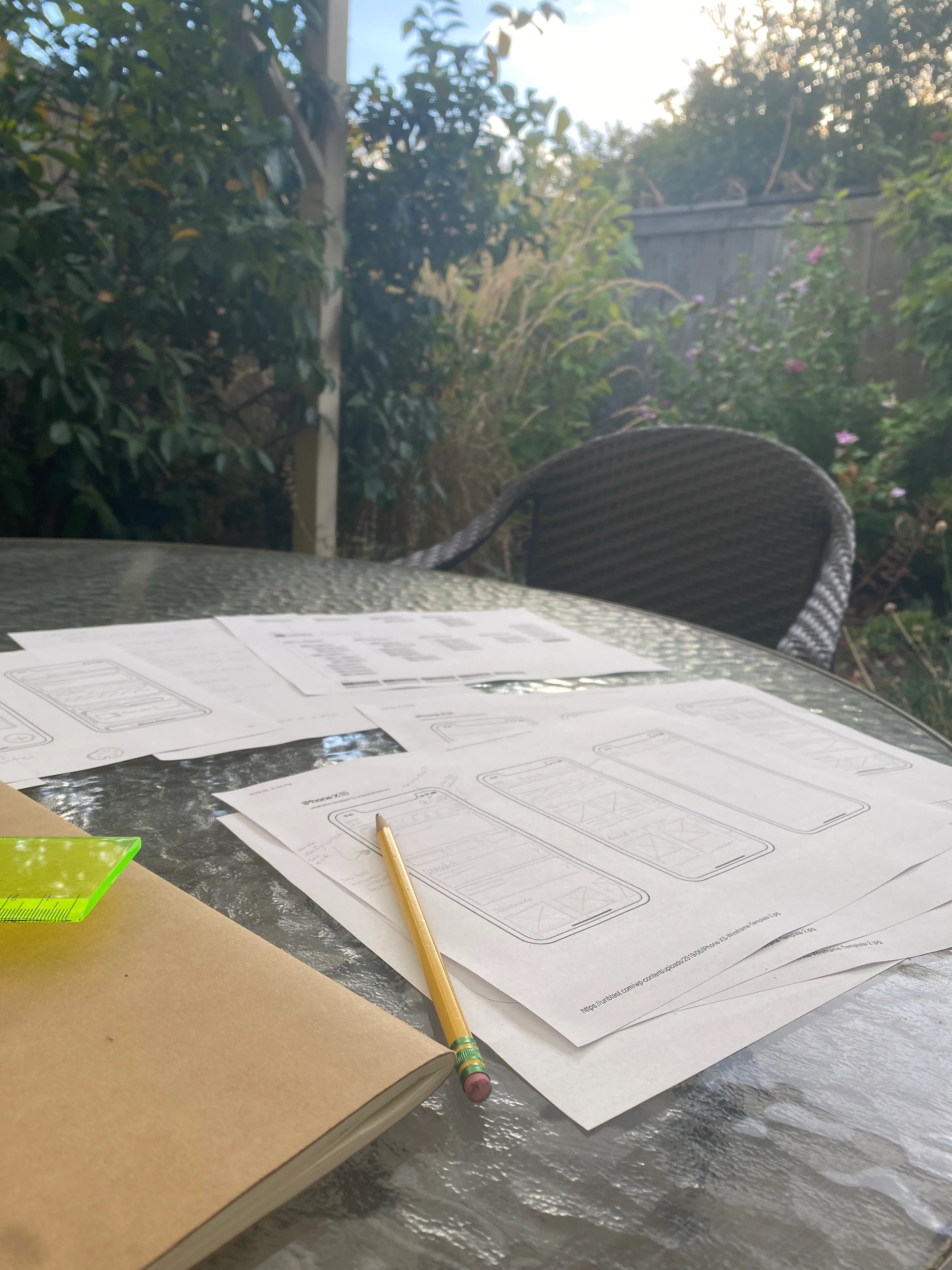 a photo of a backyard garden table where sarah was working on low fidelity wireframes