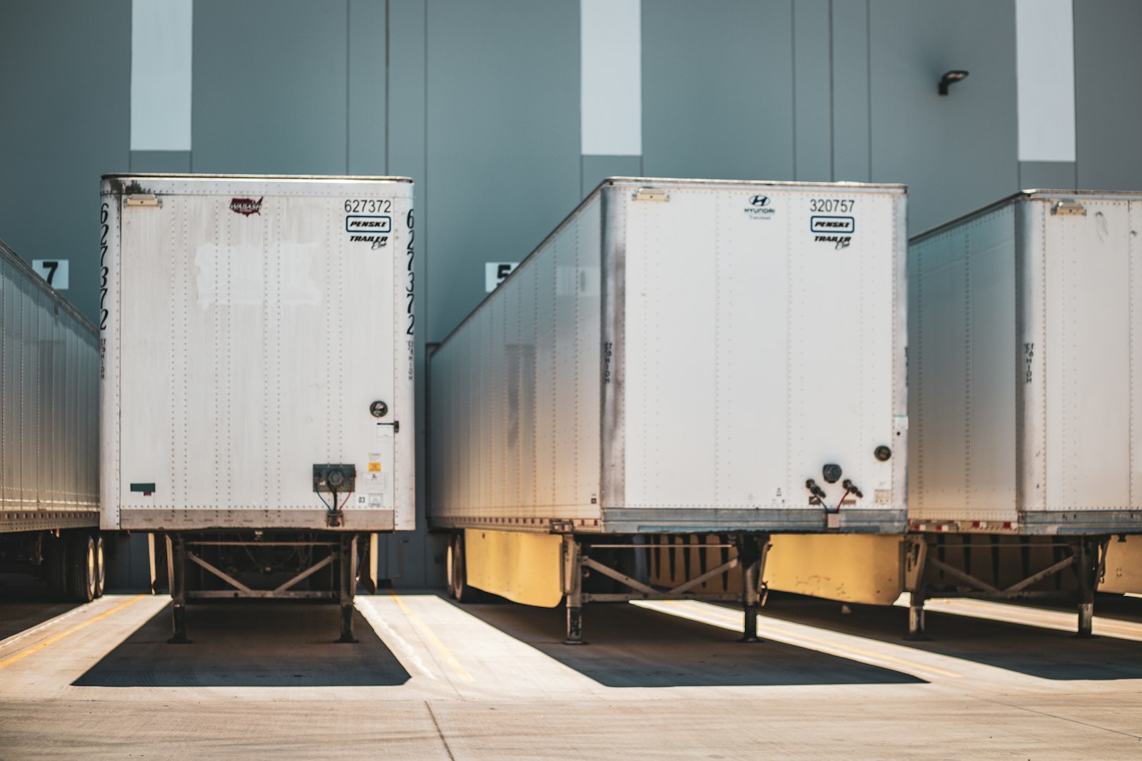Row of semi truck cabs lined up in a fleet yard