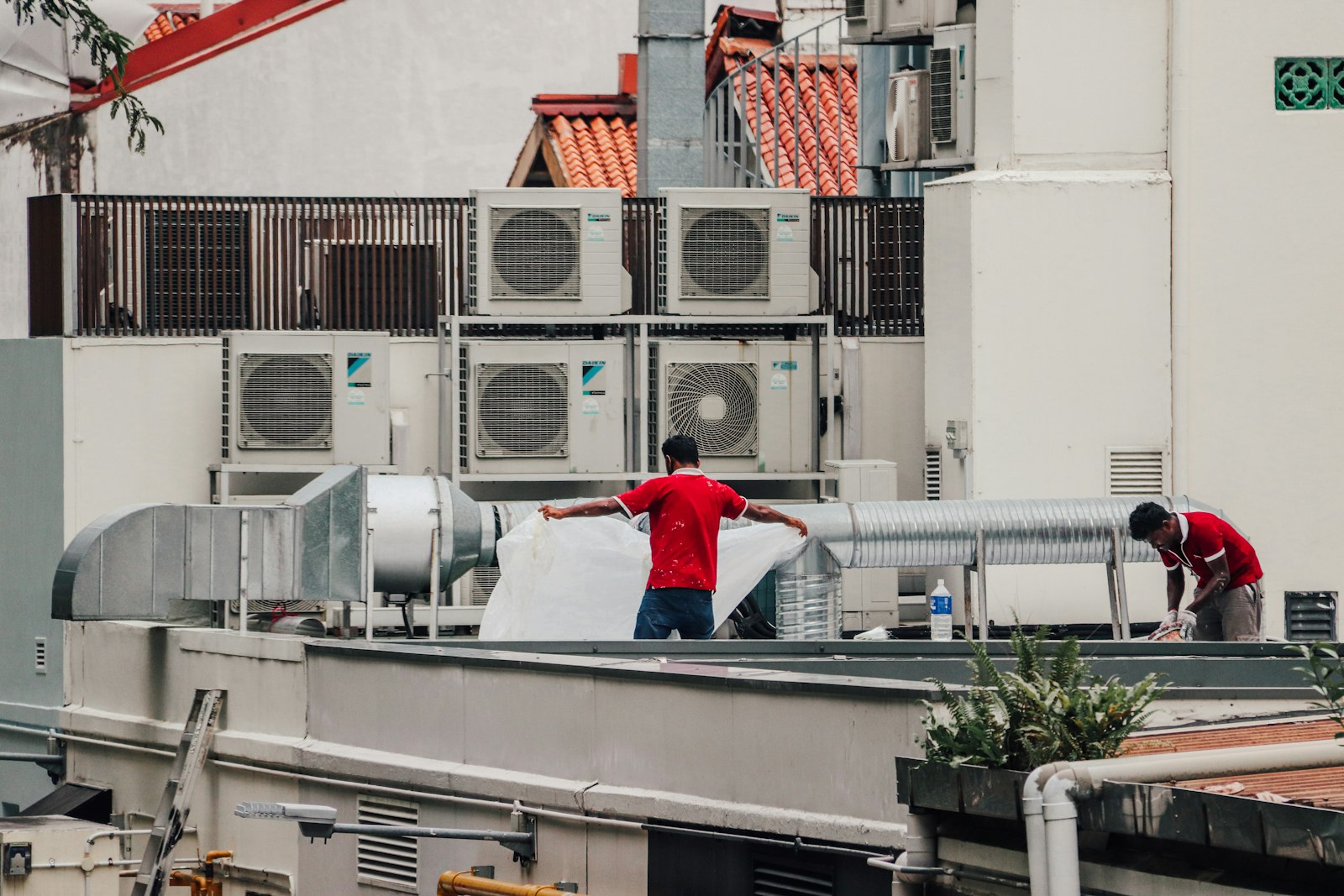 HVAC technicians servicing rooftop air conditioning units