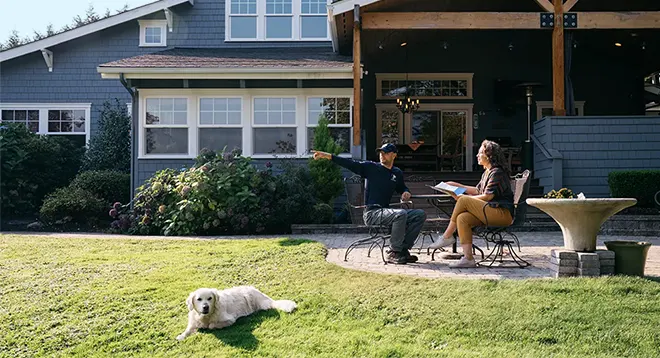 Dog Guard Dealer with customer and dog in backyard.