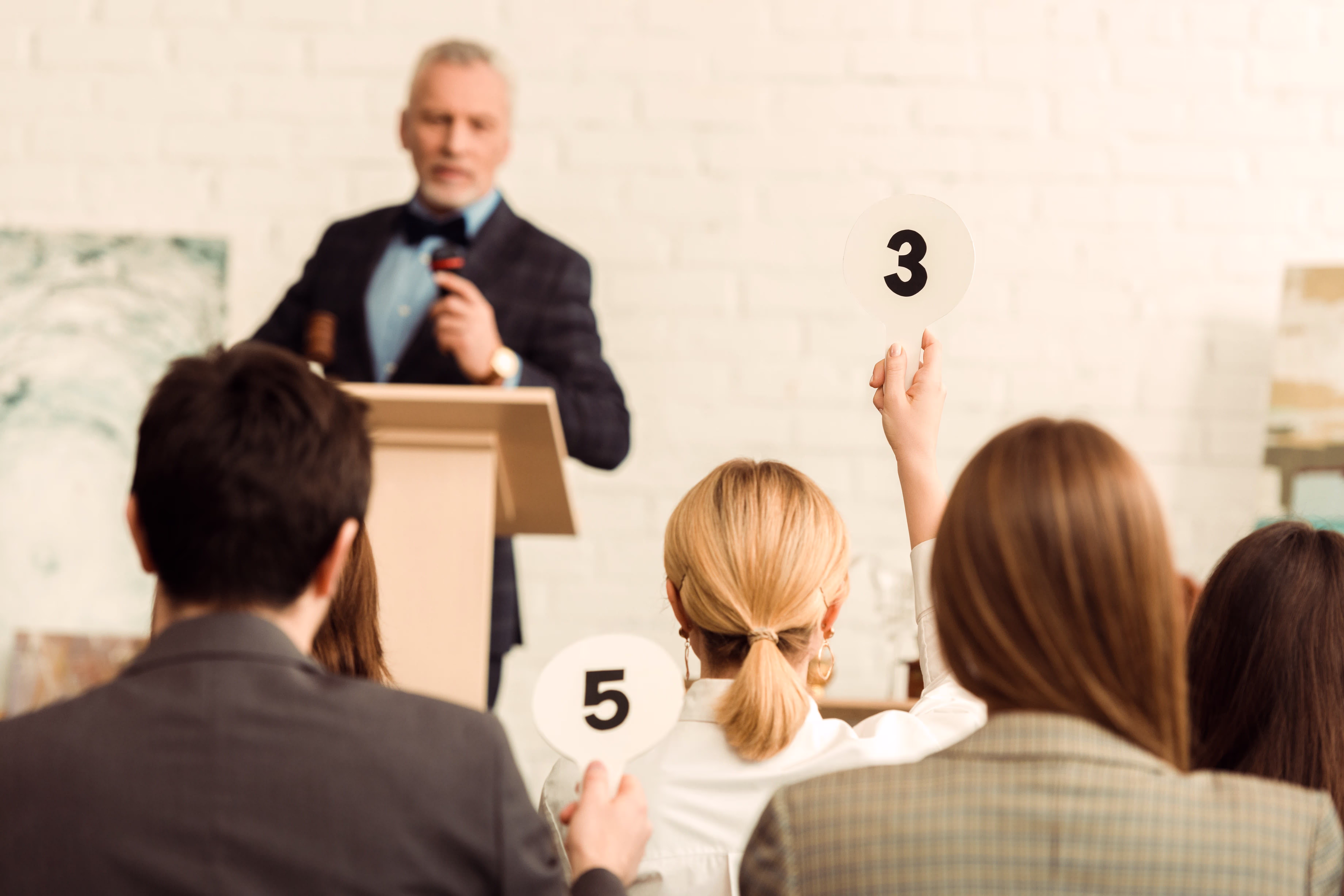 Auctioneer running a paddle raise