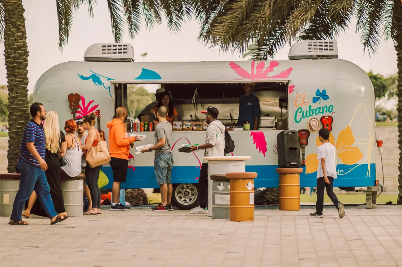 People lined up outside of a food truck