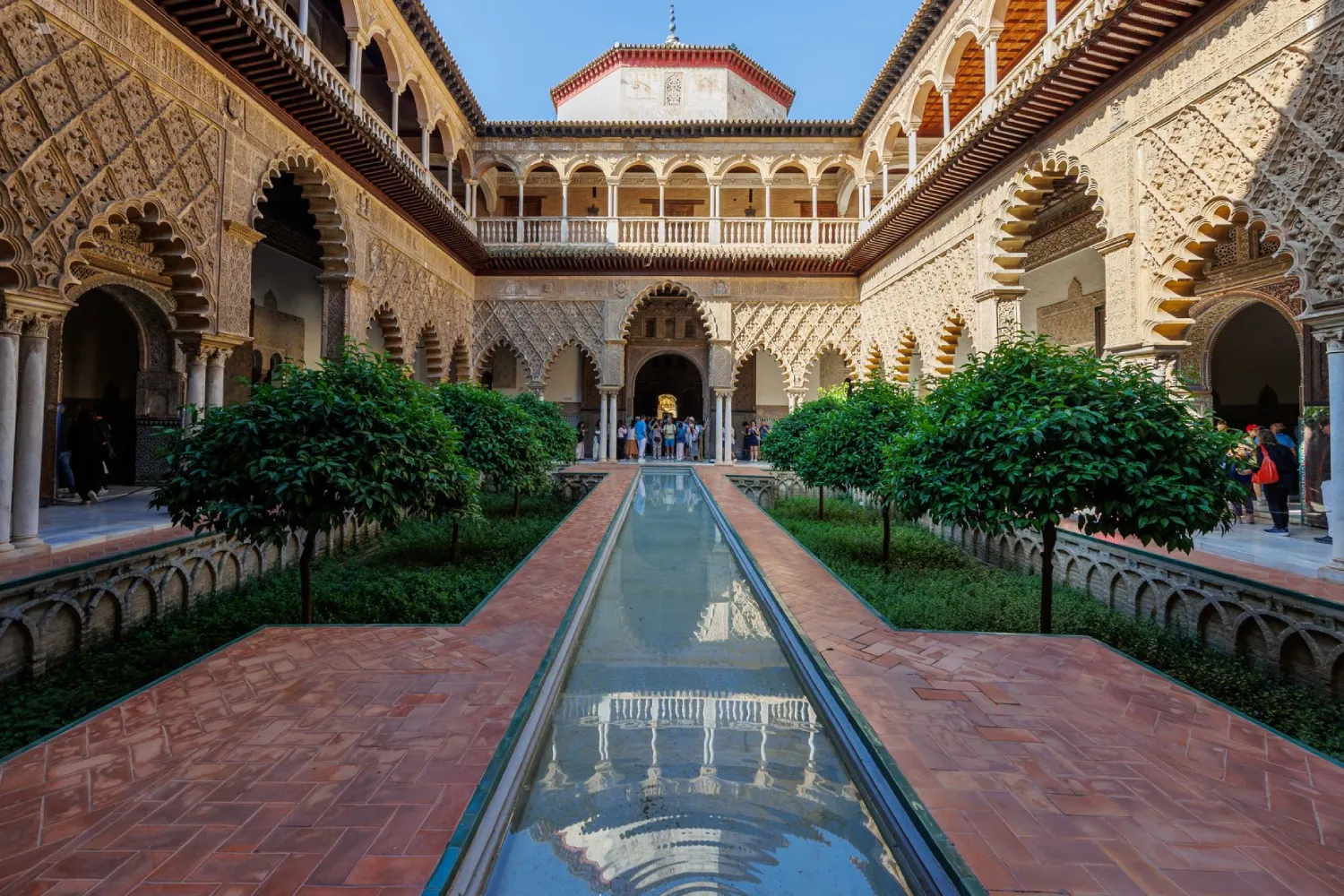 Pátio interno do Real Alcázar de Sevilha, com jardins e fonte de água