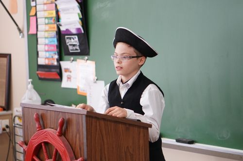 Kid talking in front of class
