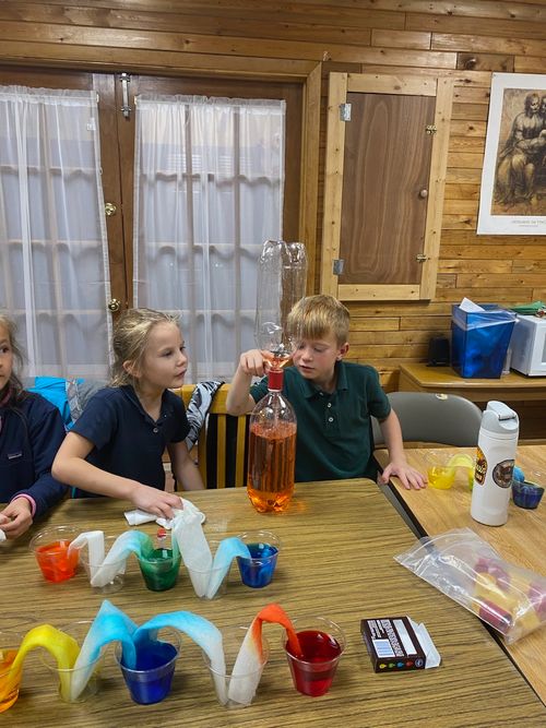 two kids at school doing science