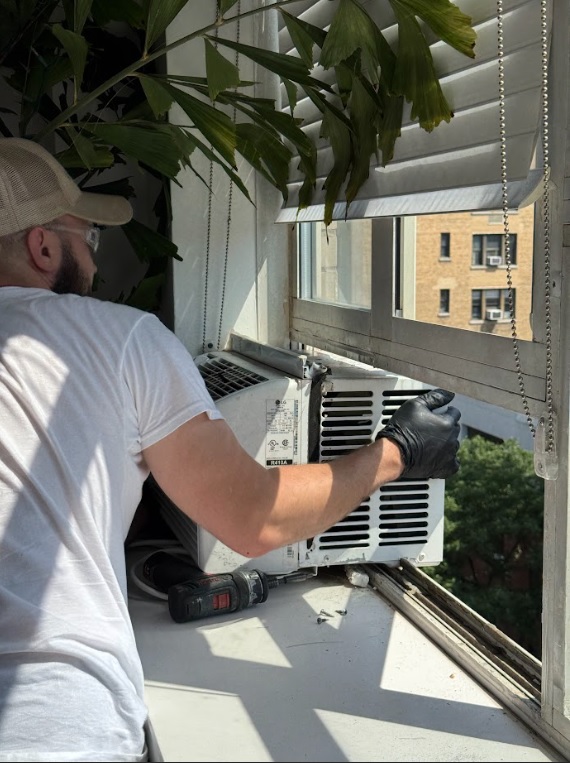 Technitian replace window ac unit