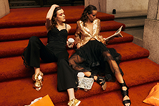 two women sitting on a set of stairs