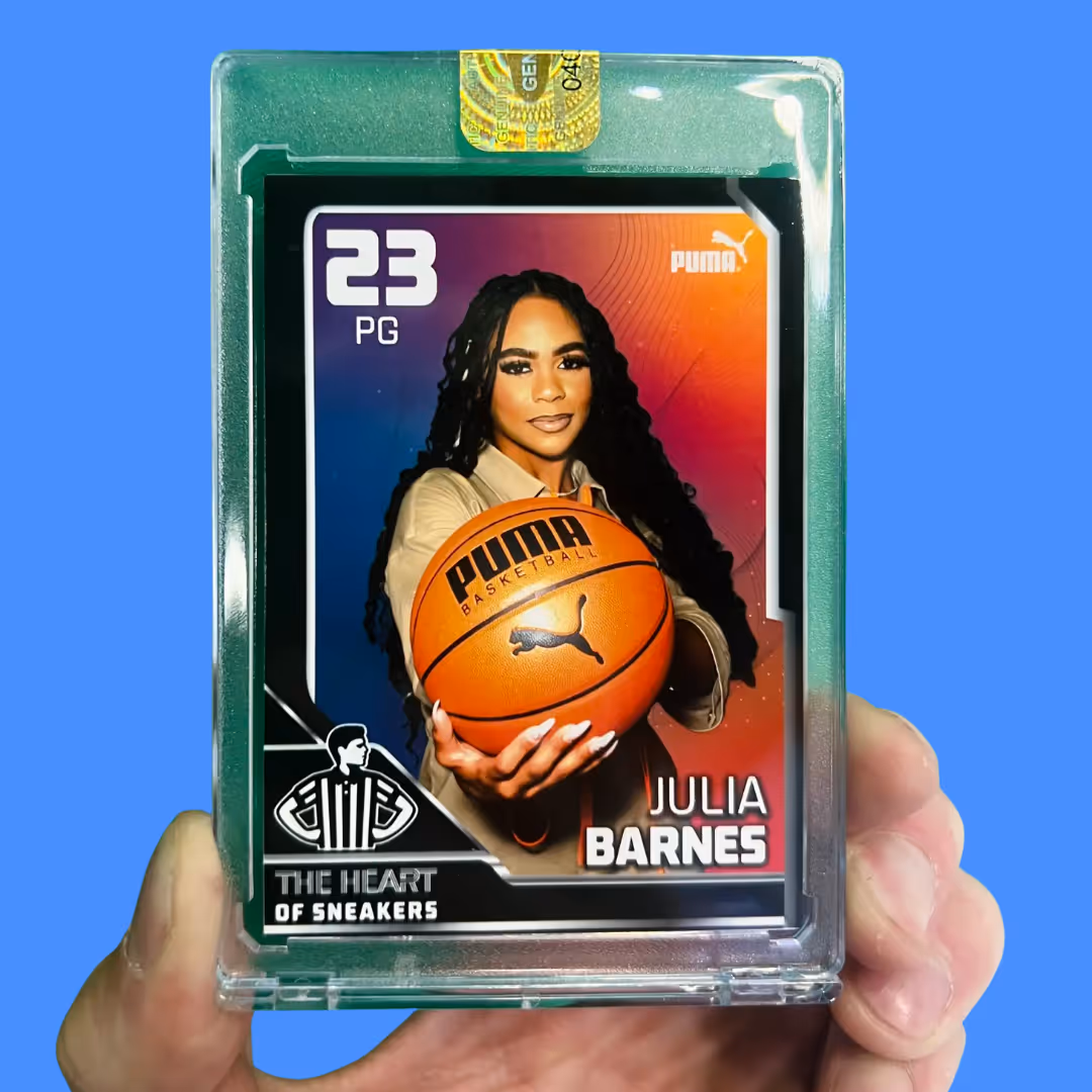 Sports card of Julia Barnes holding a Puma basketball, number 23 point guard, in protective case.