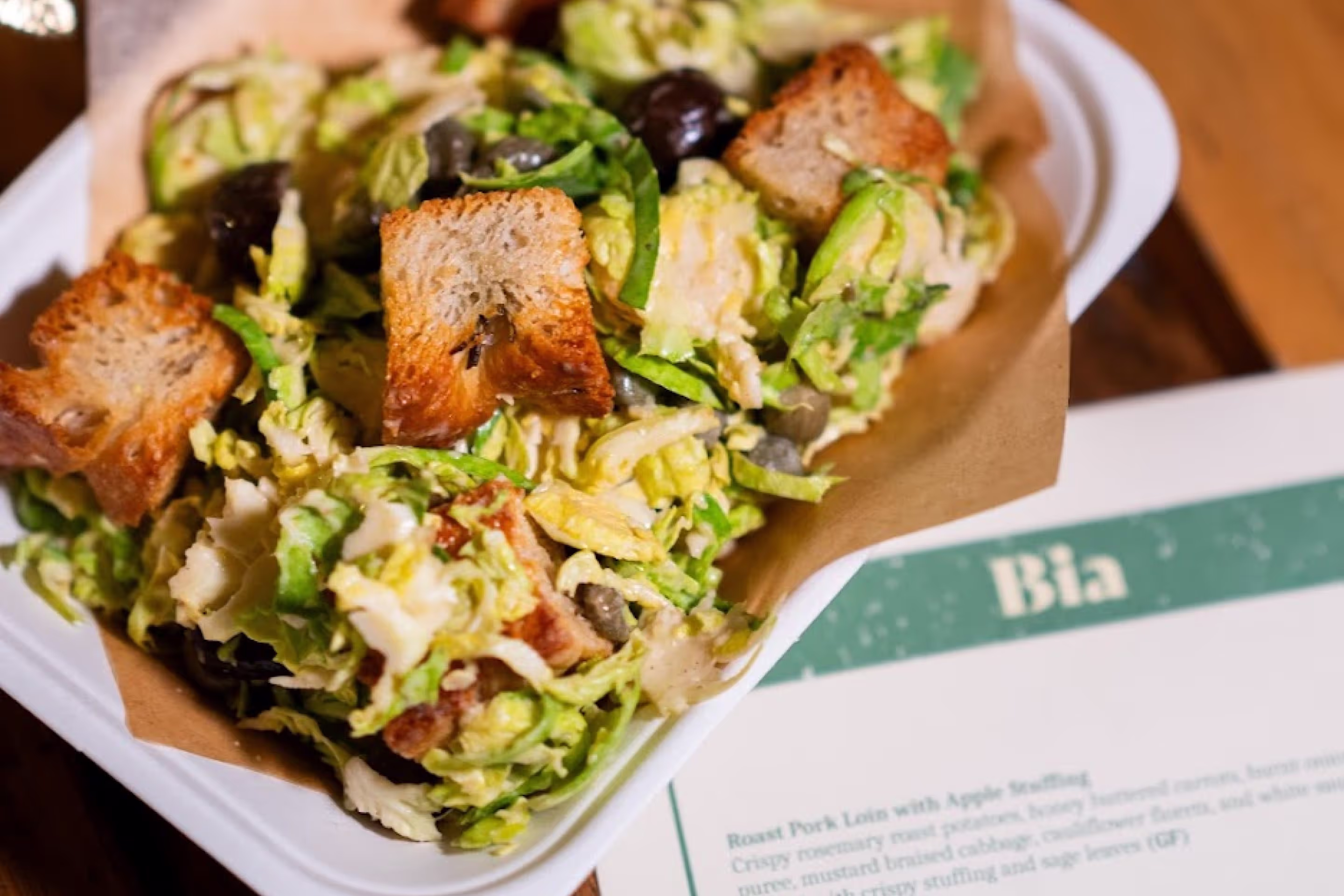 A dish by Bia next to a paper menu