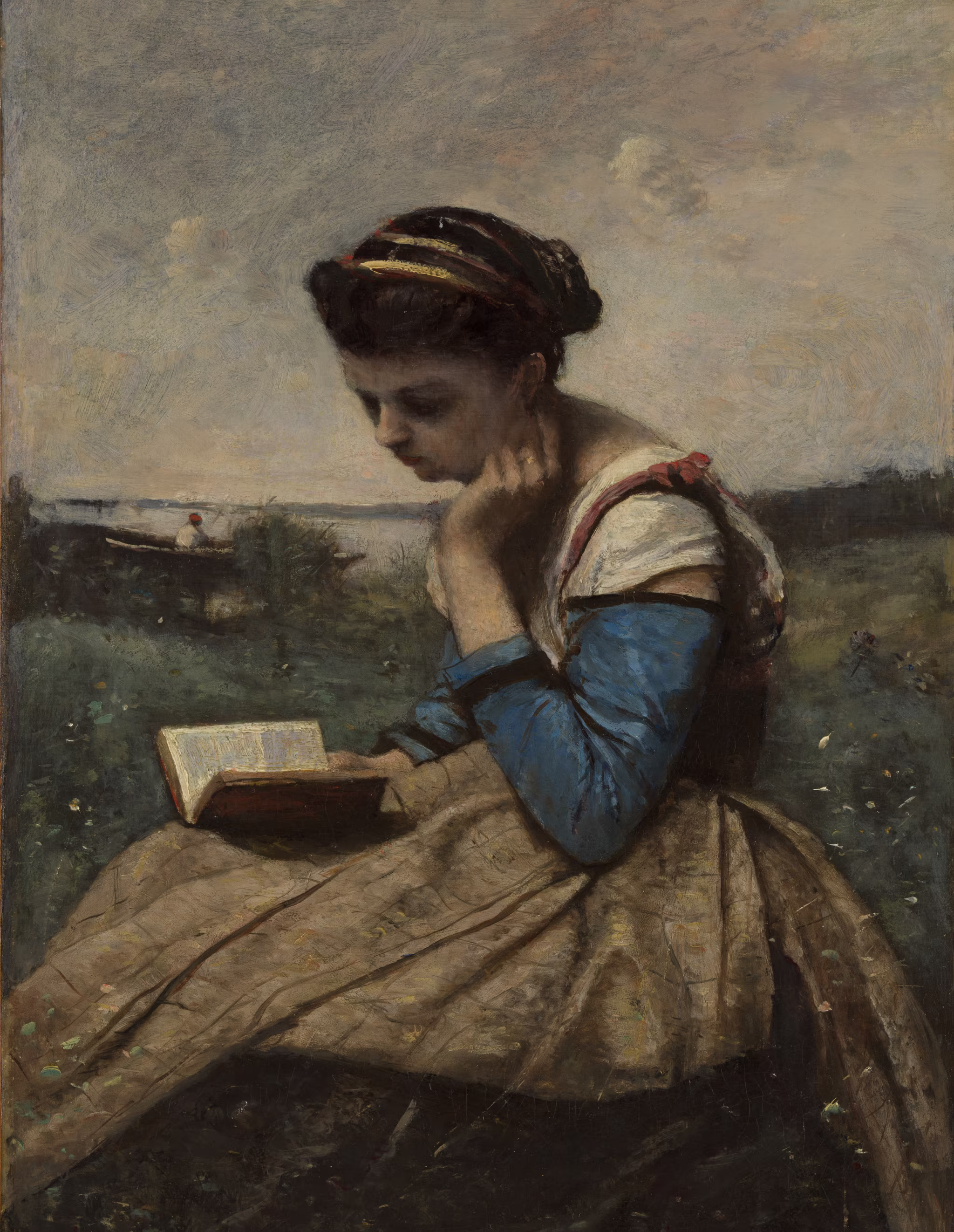 A painting by Jean-Baptiste-Camille Corot made in 1868–1870 depicting a young woman sitting in a field, wearing a blue and tan dress, and reading a book. The background shows a calm landscape with a distant boat and hazy sky.