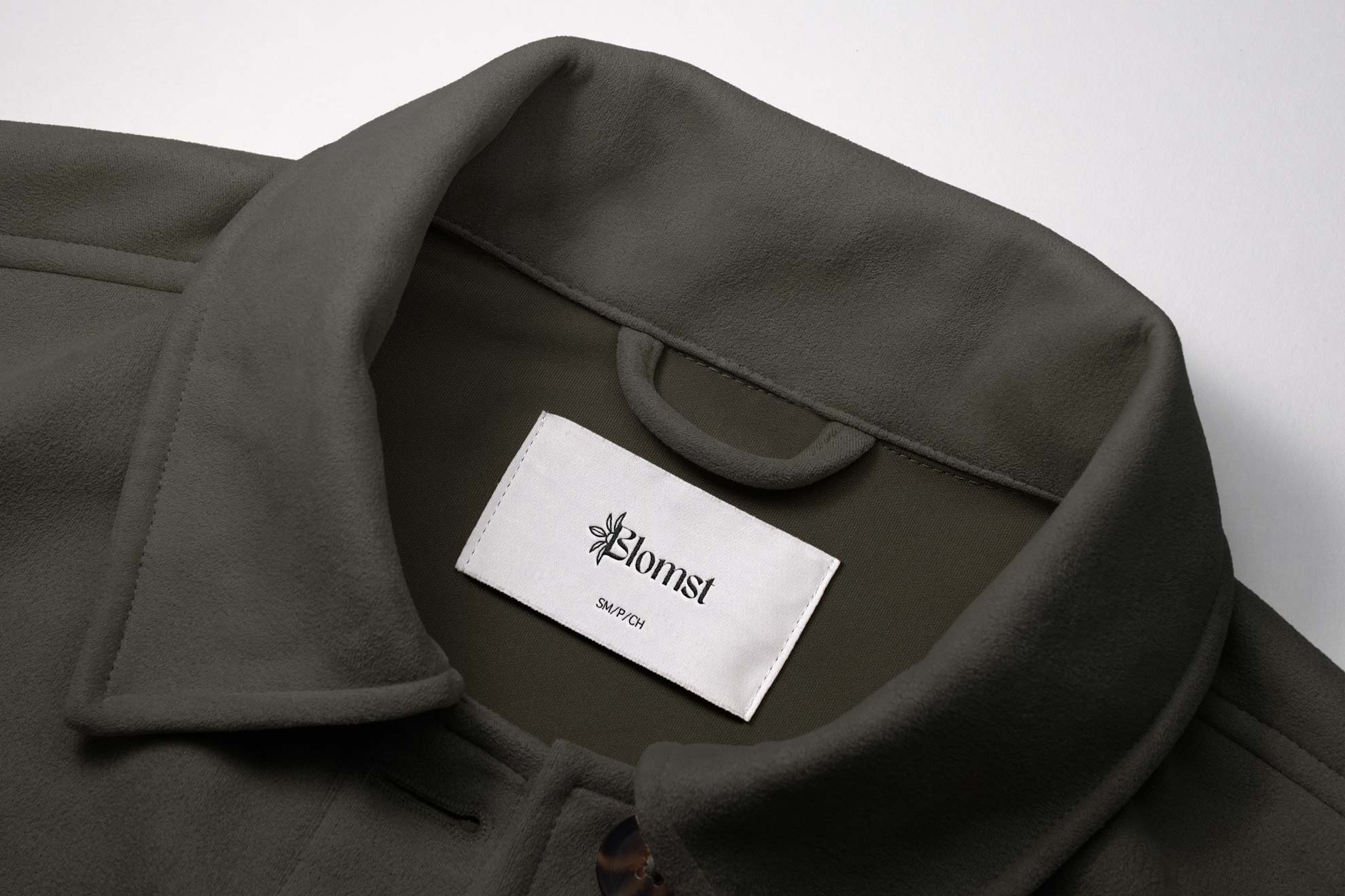 Blomst logo embroidied onto clothing tag of jacket