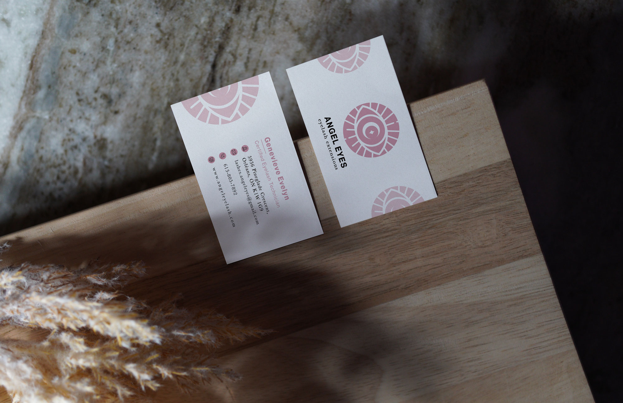 Angel eyes business cards placed on a wooden board with overcasting shadow