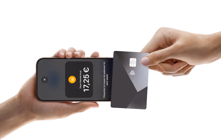 Hand holding a smartphone displaying a payment of 17.25 euros with another hand holding a credit card tapping it on the phone for contactless payment.