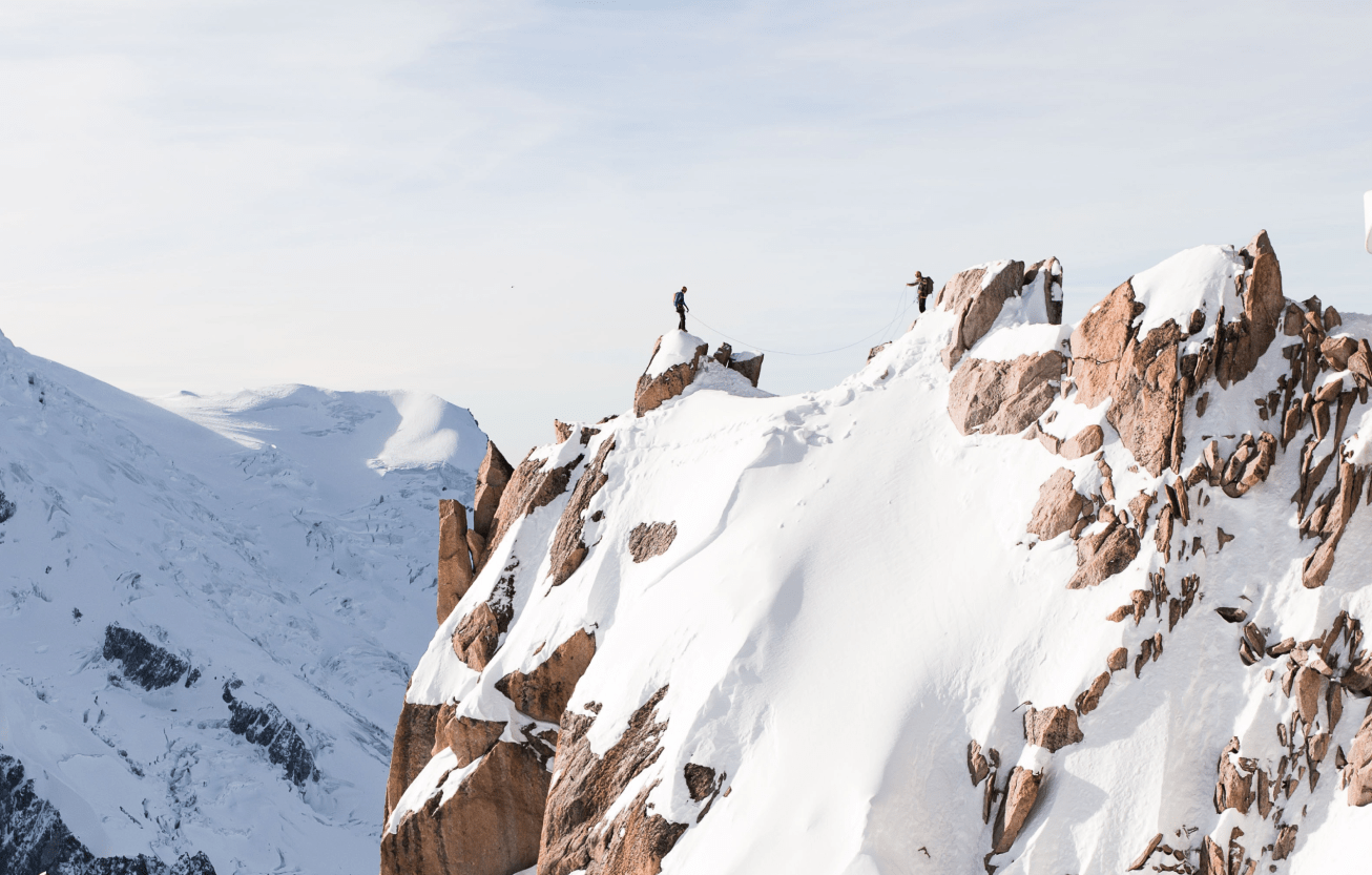 two people at the peak of a mountain