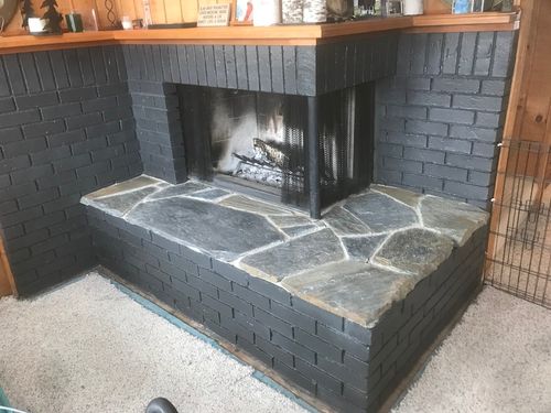 A new stone hearth and painted brick fireplace