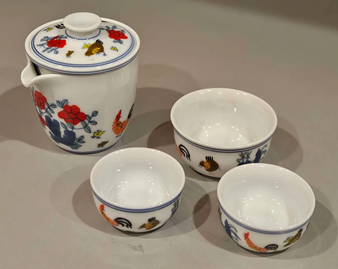 A tea pot and cupsAI-generated content may be incorrect.