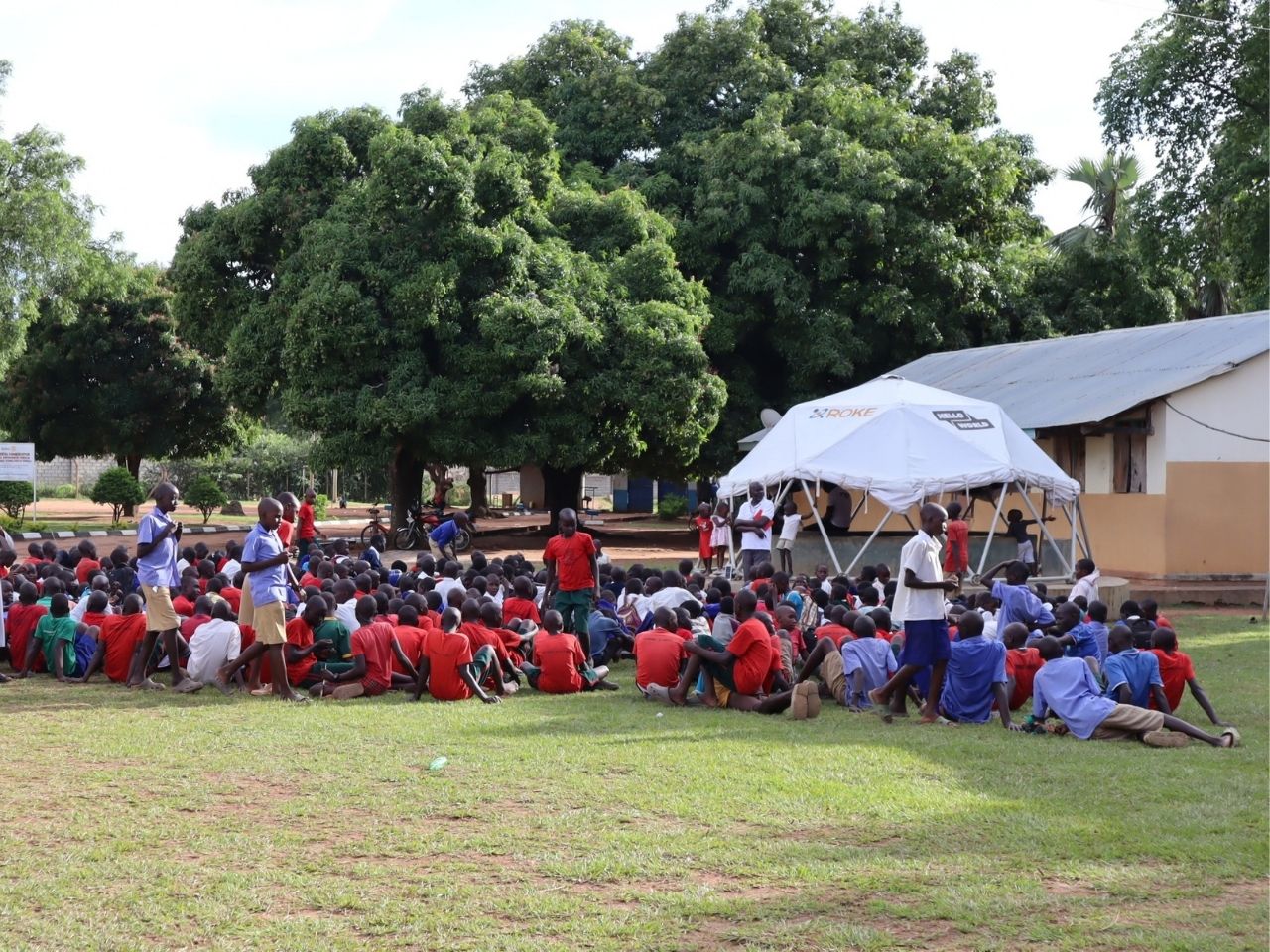 Children accessing digital learning resources through a solar-powered Hello Hub in Uganda.