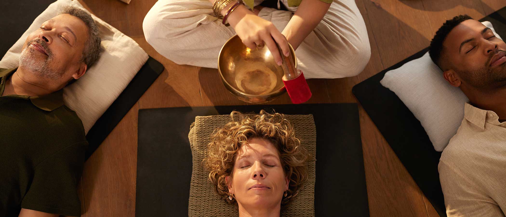 A group of people having a sound bath at a healing center.