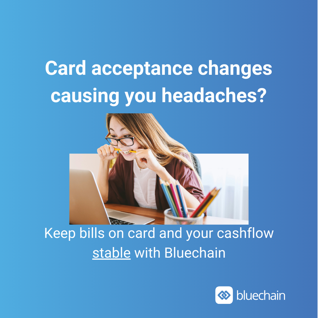 Small business owner reviewing supplier invoices and credit cards after losing an Amex payment route