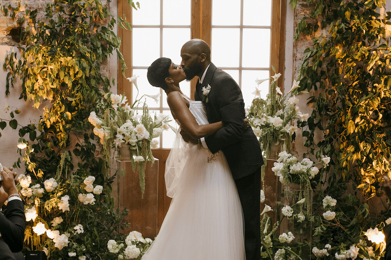 A lush celebration in a historic venue, where timeless architecture met vibrant greenery to create jungle-chic atmosphere.