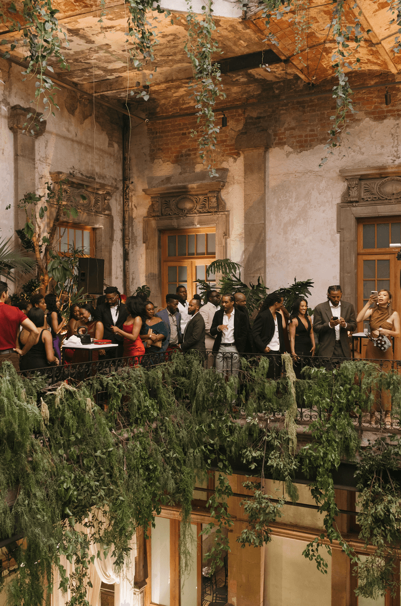 A lush celebration in a historic venue, where timeless architecture met vibrant greenery to create jungle-chic atmosphere.