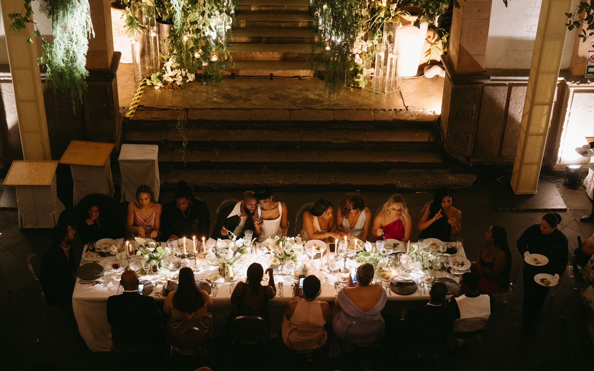 A lush celebration in a historic venue, where timeless architecture met vibrant greenery to create jungle-chic atmosphere.