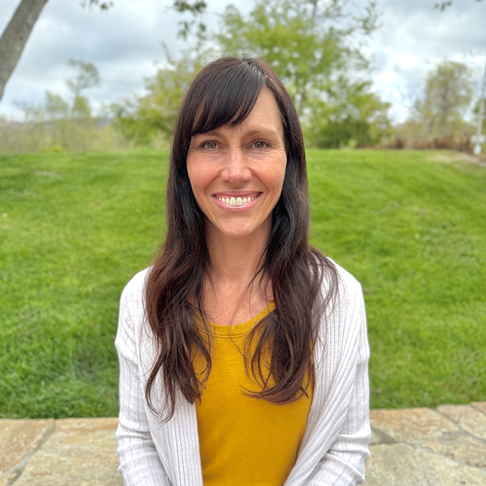 Rebecca Guss, speech-language pathologist and owner of Speech-N-Motion, smiling outdoors in San Marcos, California.