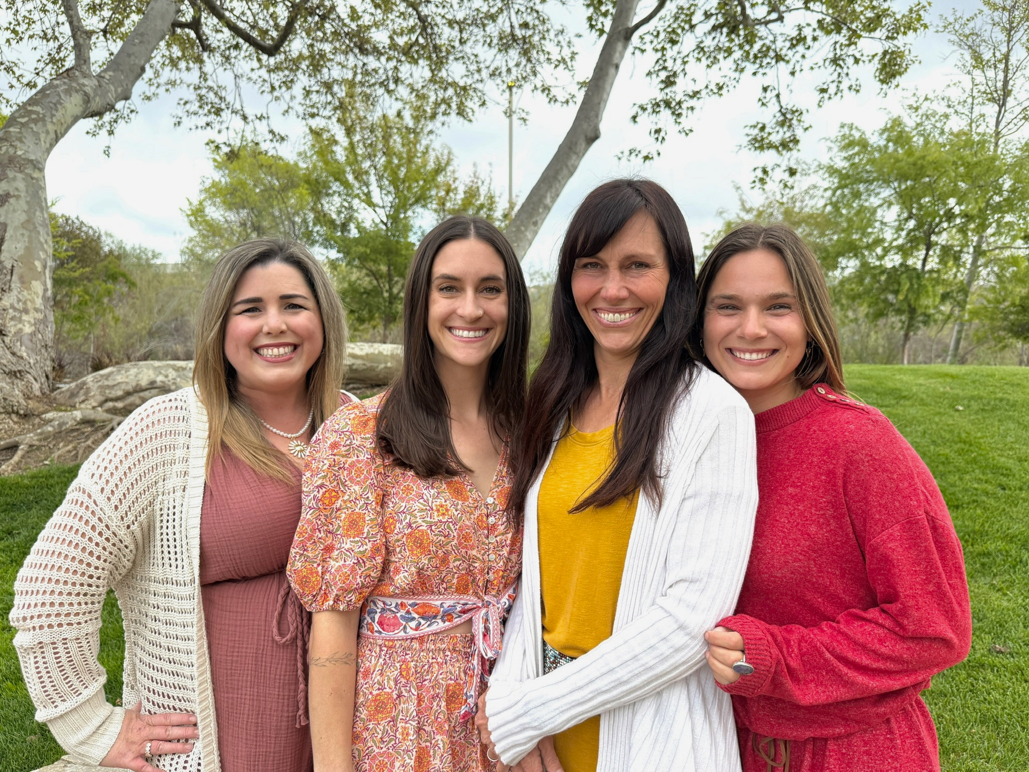 Four speech-language pathologists from Speech-N-Motion standing outdoors under a tree in San Marcos, California