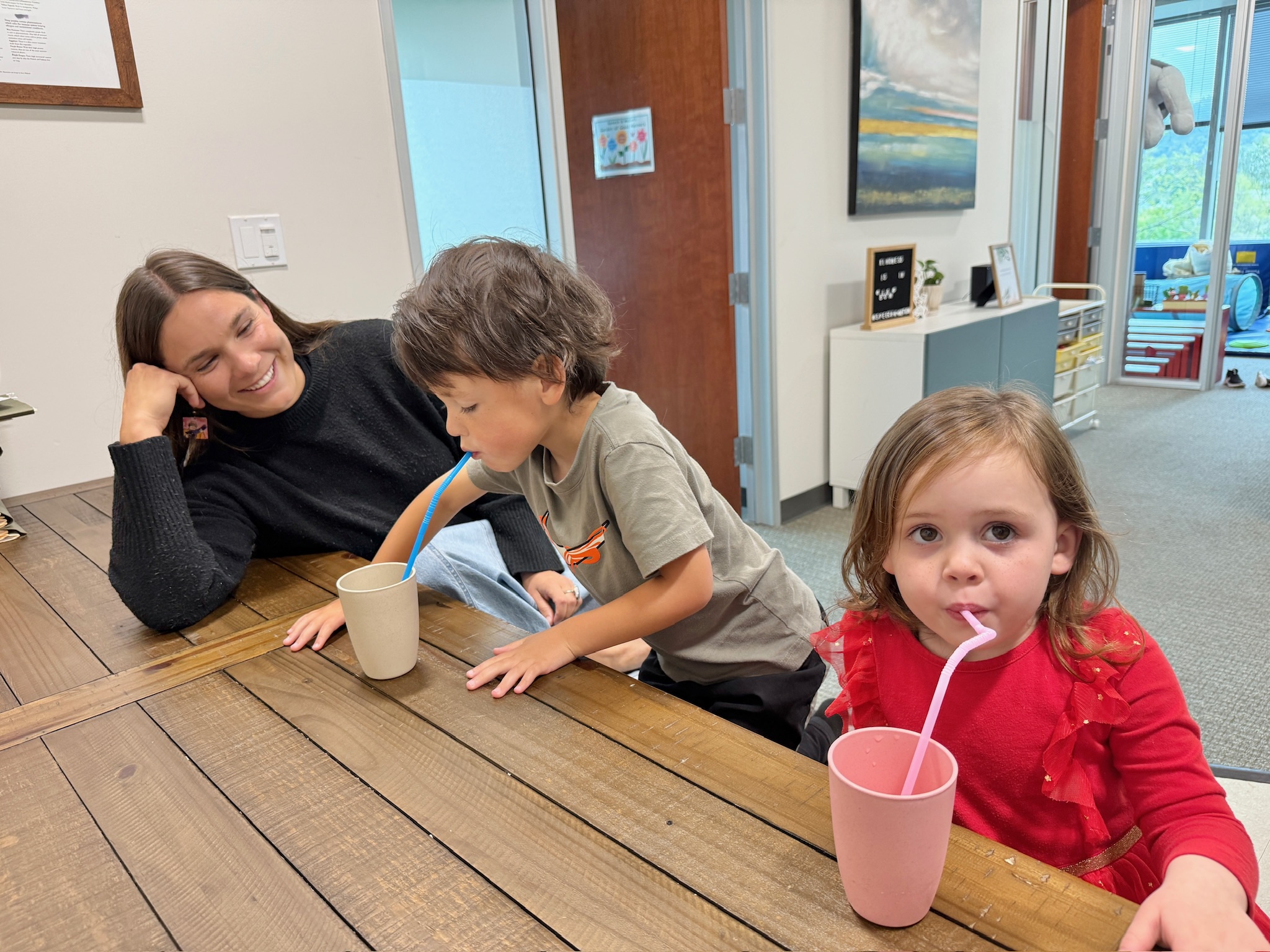 Speech-language pathologist engaging a young boy in a tabletop activity to support speech and language development at Speech-N-Motion in North County San Diego.