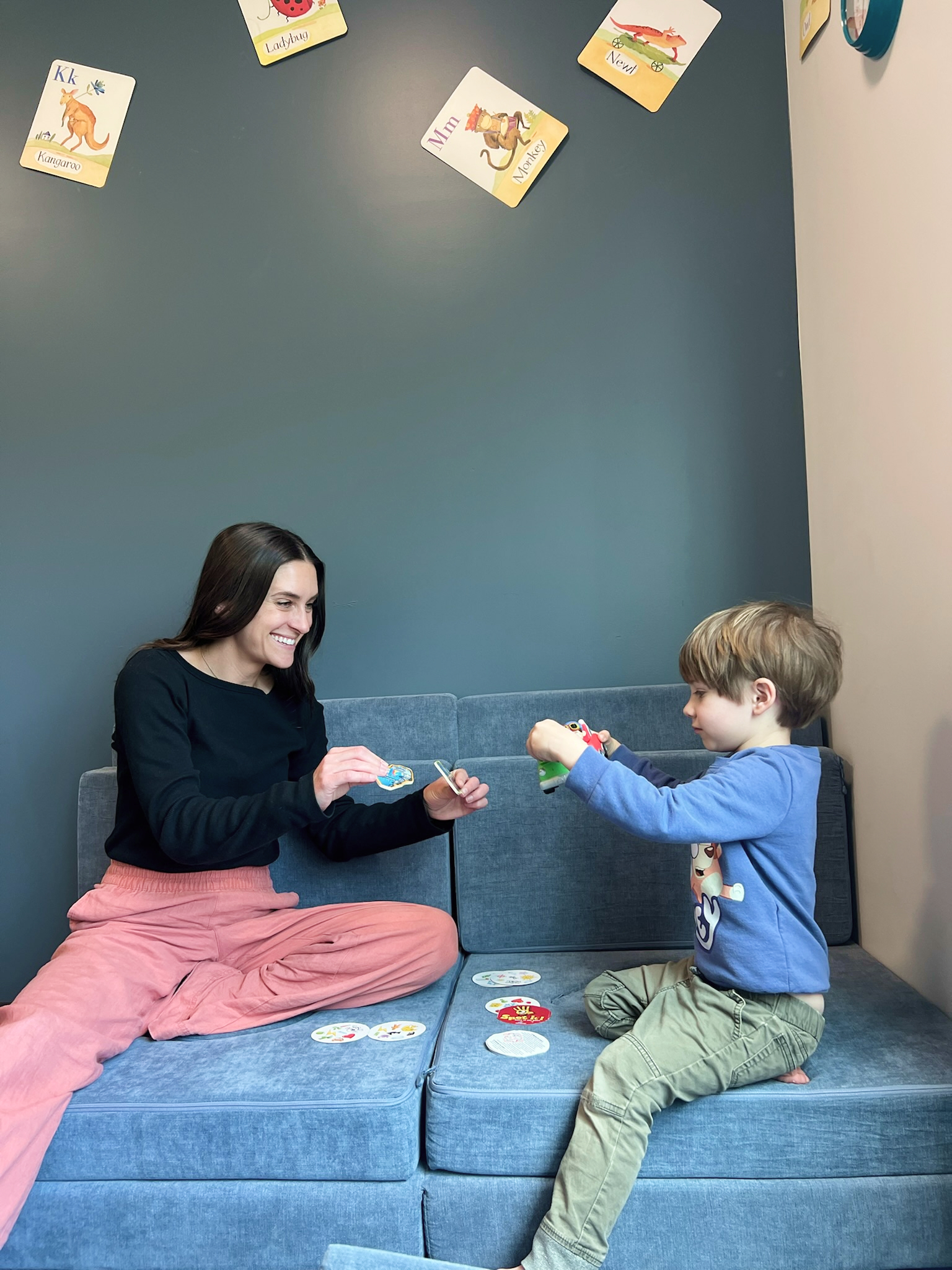 Speech-language pathologist working with a young boy using toys during a speech therapy session at Speech-N-Motion’s San Marcos, California clinic.