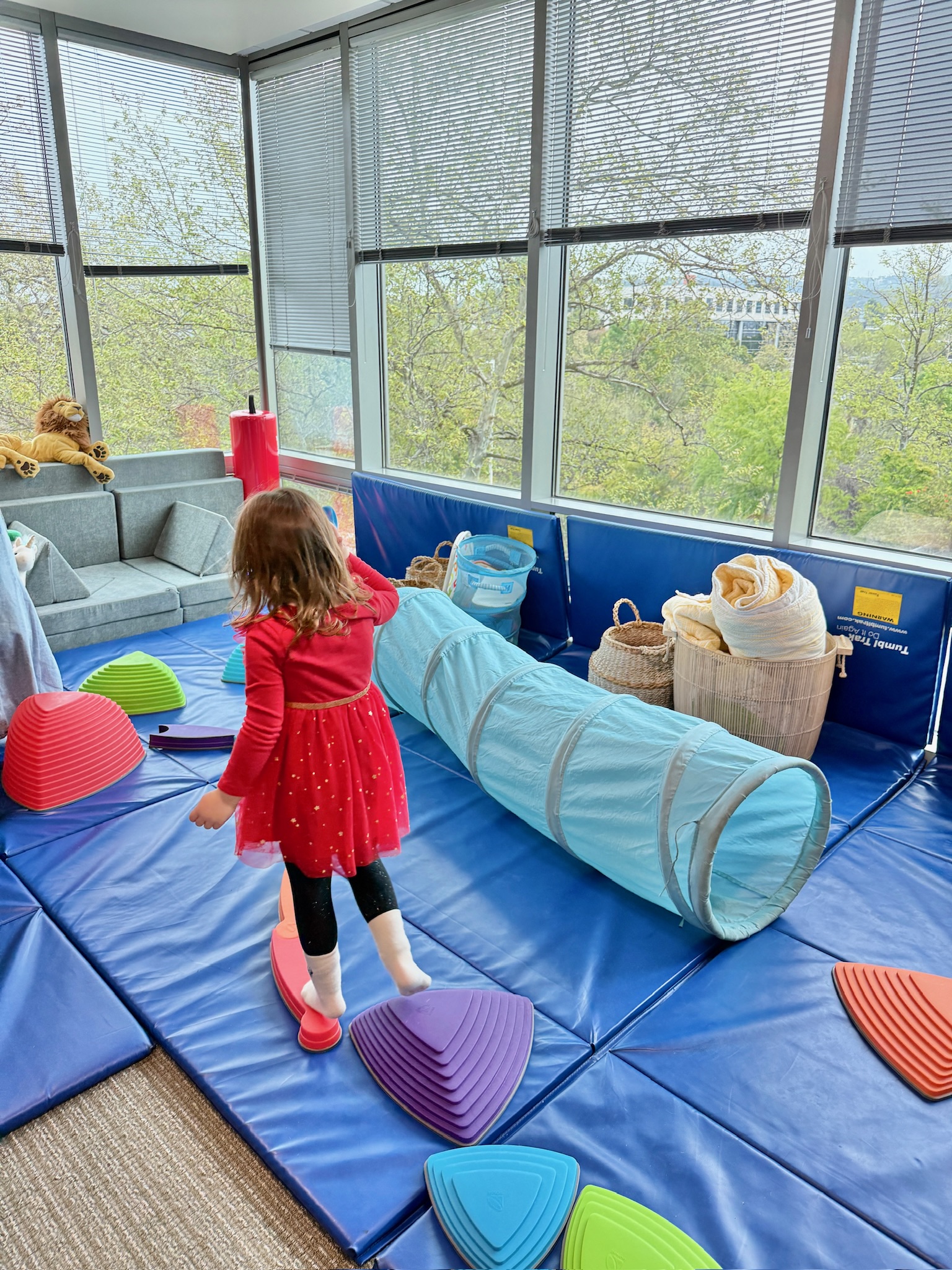 Child walking on balance equipment during a play-based speech therapy session at Speech-N-Motion in San Marcos, California.