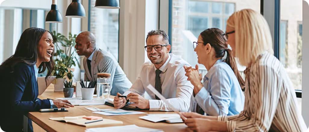 Sales and operations team sitting together in a modern office during a team meeting