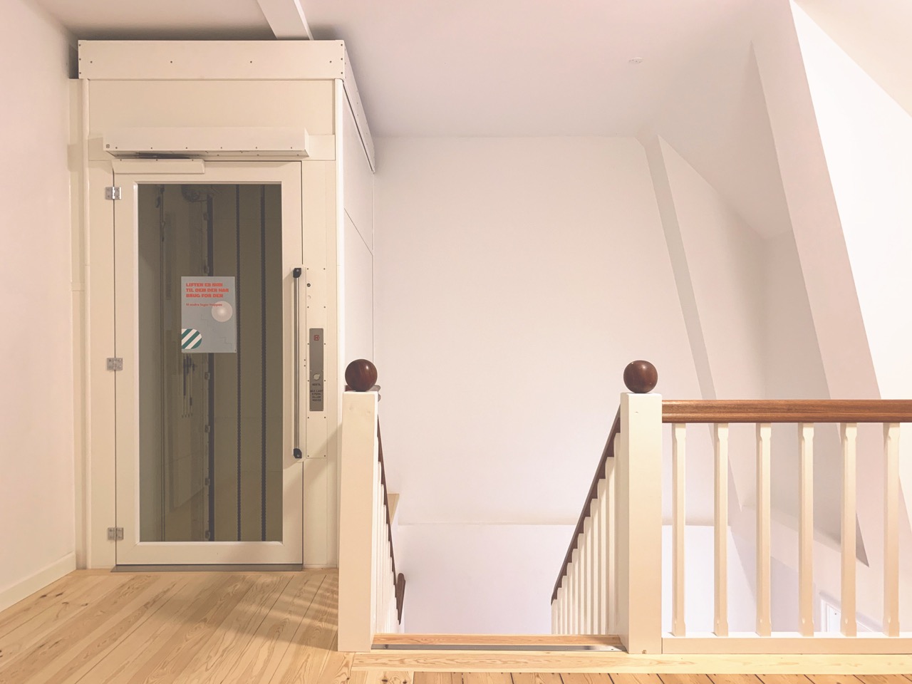 Øverste repos på trappe med eletorlift ved siden af.
