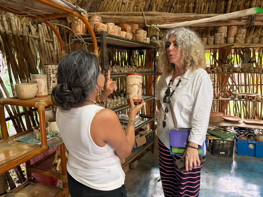 Patricia Martín Morales presents a ceramic vessel to Ivonne Ferrer