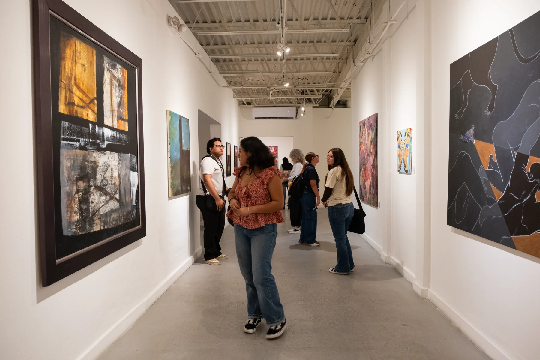 Gallery visitors explore the MoCAA Collection in Yucatán exhibition