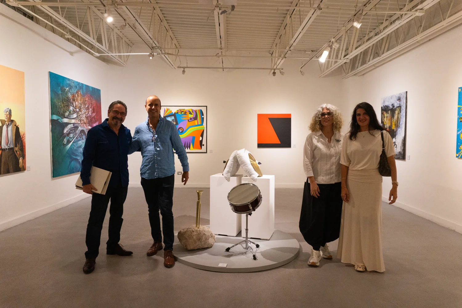 Exhibition organizers and guests pose in the gallery