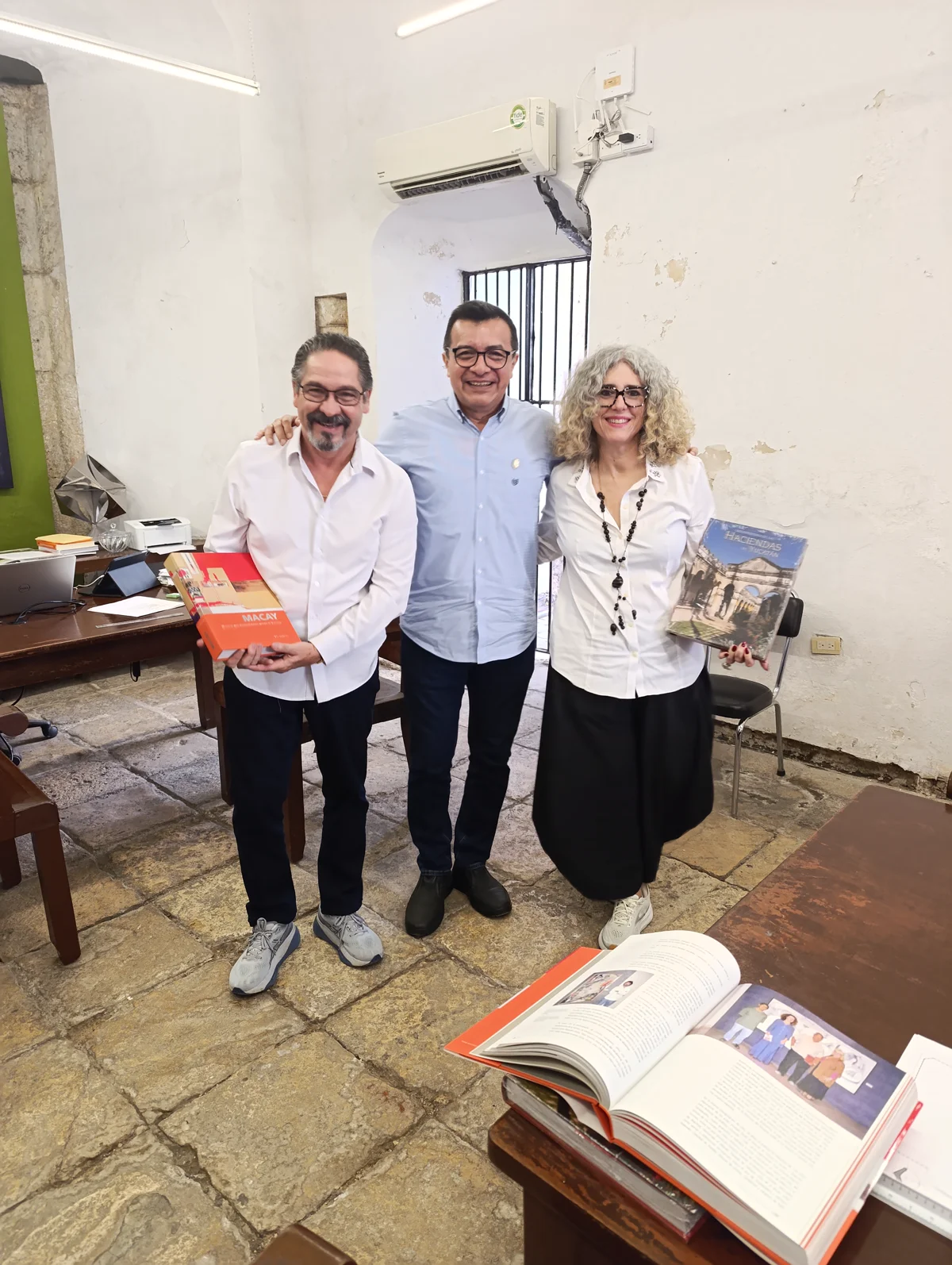 UADY and MoCAA representatives display the donated books