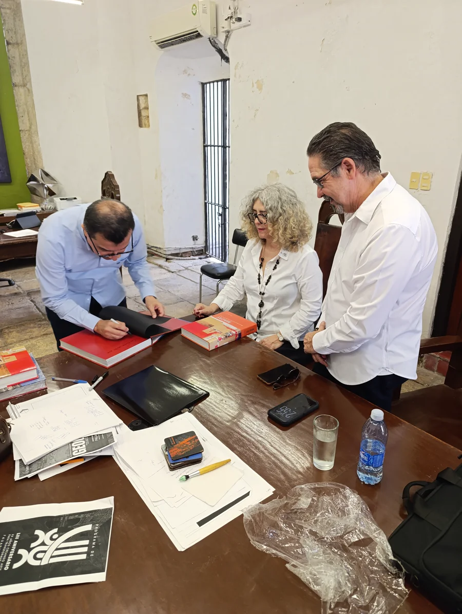 Representatives sign and dedicate a donated book