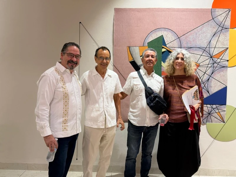 Ivonne Ferrer and guests beside a work in the exhibition