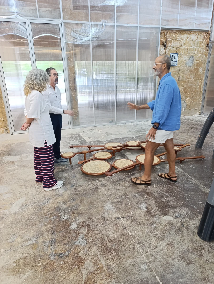 Marcos Castillo shows a wooden sculpture to MoCAA visitors