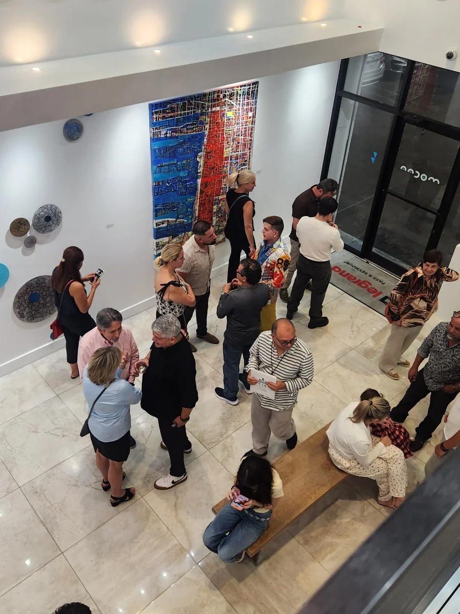 Visitors at the opening of Beauty as Protest at MoCAA, seen from the mezzanine.