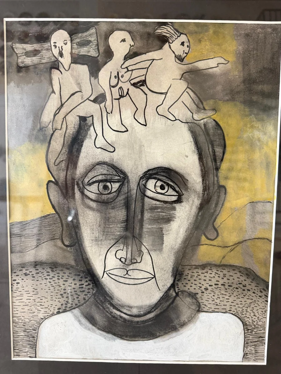 Work by Alejandro Lorenzo Valdés (ALEVAL): a large face with three small figures seated on top of the head.