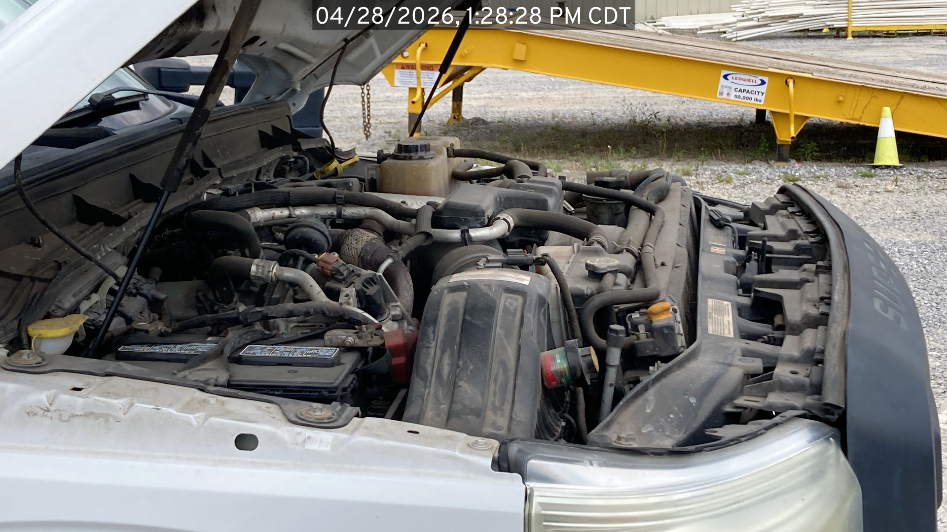 Image of the Ford F250 listed for sale, showing under the hood viewing from the passenger side of the vehicle.