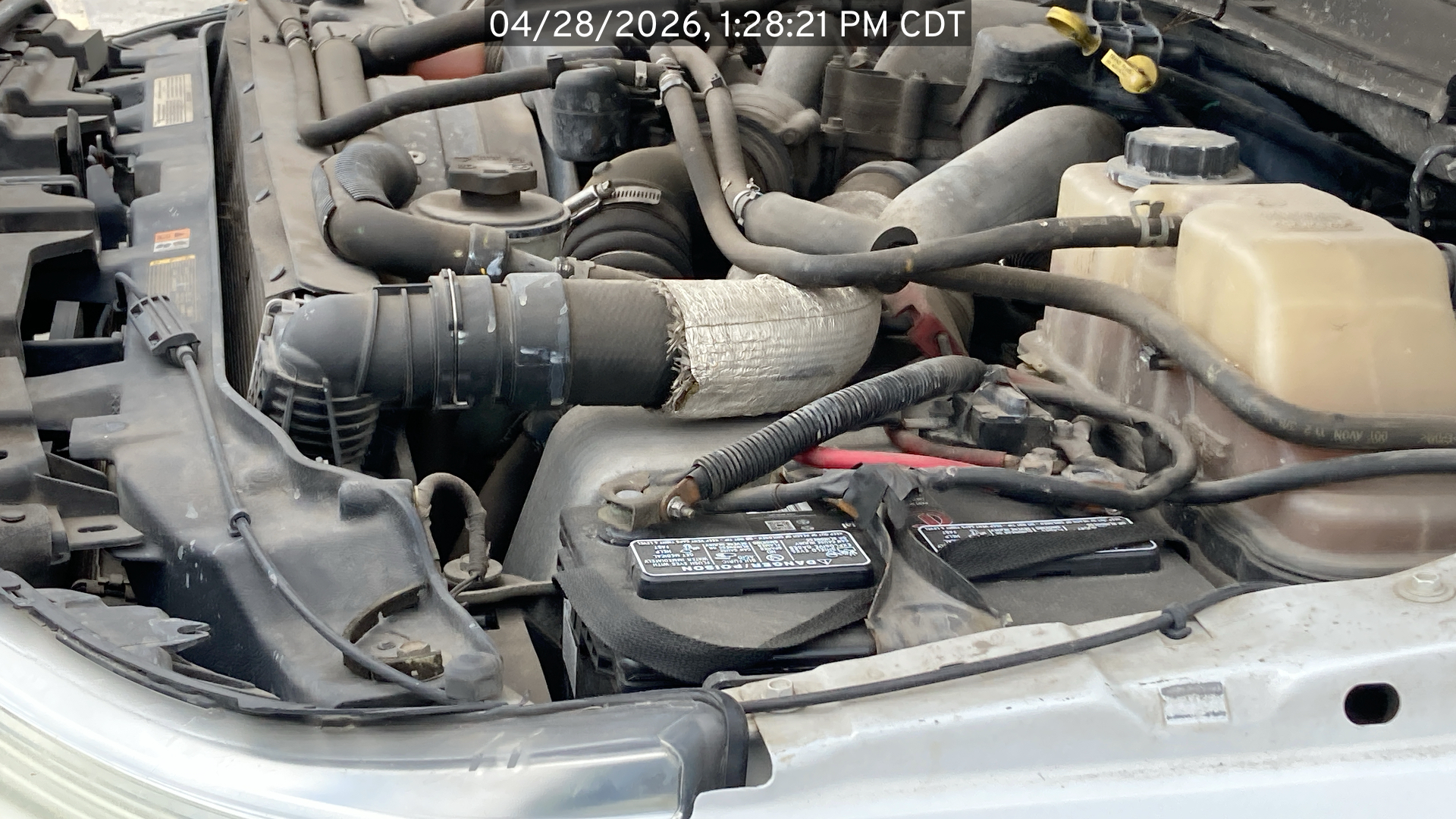 Image of the Ford F250 listed for sale, showing under the hood viewing from the driver side of the vehicle.