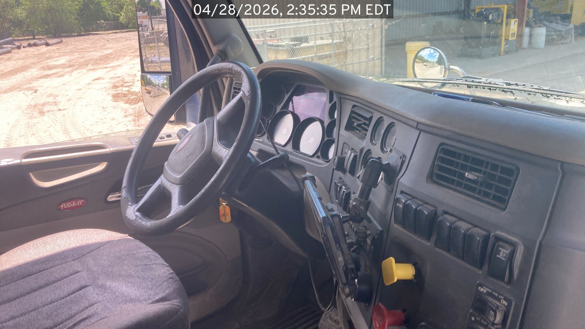 Photo of the Peterbilt 567 listed for sale, view inside the cab with a focus on the dash