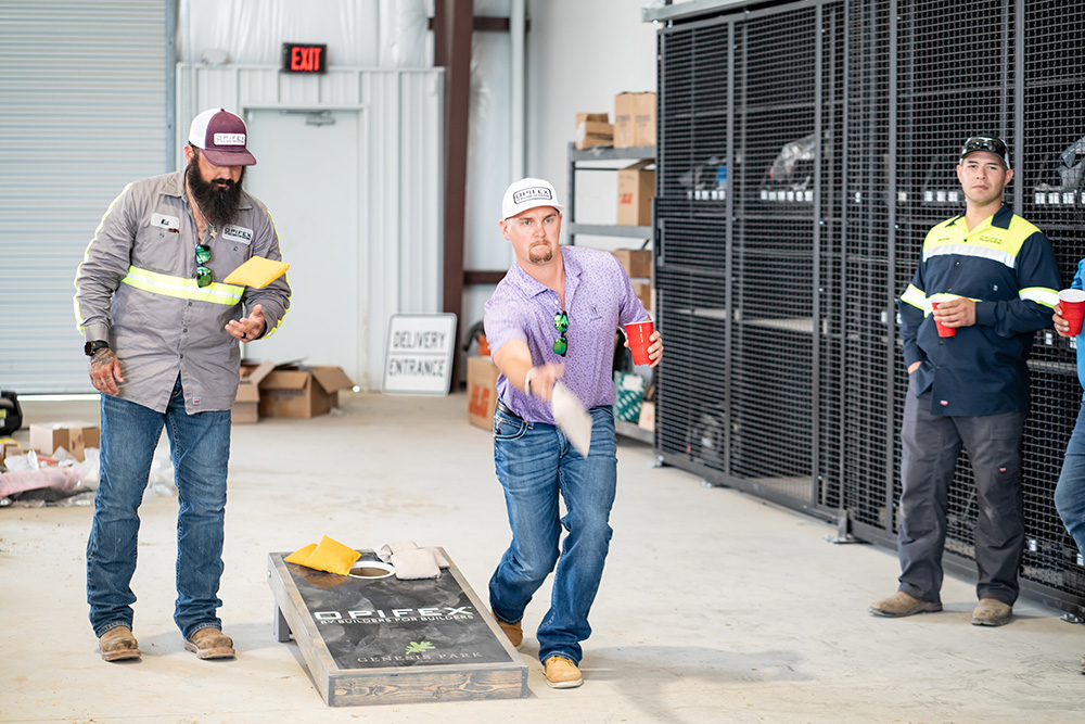 Some of our employees playing cornhole at the shop