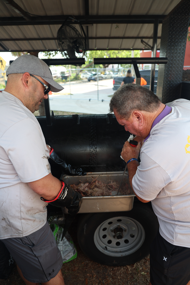 Two of our team members prepping food at the 2025 BBQ Love event in Tampa